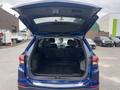 A 2022 Chevrolet Equinox with the rear hatch open, revealing a spacious cargo area with black floor mats and seating for five visible in the front.