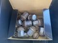A box containing several metal lug nuts used for securing wheels on a 2021 RAM 1500