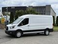 A white 2022 Ford Transit van with a high roof and sliding side door parked on a lot