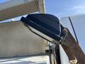 A close-up view of a black spotlight attached to a metal bracket on the side of a Ford F-450 SD truck