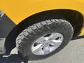 Close-up of a rugged tire on a 2015 RAM 1500 showcasing tread patterns and aluminum alloy wheel