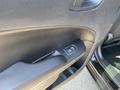 Close-up of the interior door panel of a 2019 Dodge Charger showing the window control button and textured surface