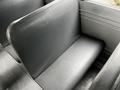 Close-up of a black seat in a 2015 Spartan School Bus showing a smooth textured surface and a simple design for passenger seating