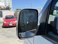 A side mirror of a 2006 Ford Econoline with a clear reflective surface