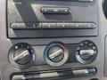Close-up of the control panel in a 2008 Ford F-450 SD featuring knobs for air conditioning and heating along with buttons for audio settings
