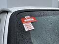 A 2013 Ford Econoline displaying a certificate of approval sticker with months January to April listed on it