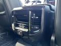 A close-up of the air conditioning controls and vents in a 2019 RAM 1500 interior showing various buttons and features