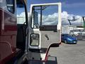 A 1994 Volvo FE 42 truck with an open driver's side door revealing the interior and controls