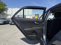 A 2018 Kia Rio5 with its front door open displaying the interior door panel and handle