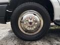 Close-up of a chrome hubcap on a tire of a 2017 Ford Econoline showing shiny lug nut covers and detailed design of the rim