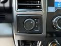 The control panel of a 2019 Ford F-550 featuring a dial for selecting 2H 4H and 4L drive modes