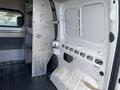 A 2013 Ford Transit Connect interior showing empty cargo space with metal shelving and paneling on the side