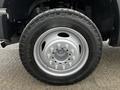 Close-up of a silver wheel and tire from a 2008 Ford F-450 SD showing lug nuts and tire tread pattern