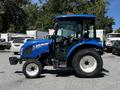 A blue 2018 New Holland Boomer 45 tractor with a closed cabin and large rear tires is shown from the side