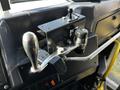 Close-up of the control panel in a 2022 Blue Bird Vision featuring gear shifters and buttons for operating the bus