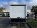 A 2021 Ford Econoline van with a large white cargo area and a black step bumper at the rear