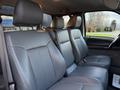 Interior view of a 2006 Ford F-650 showing gray leather seats in the front cabin with a focus on the middle seat and headrests