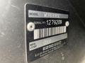 A metal identification plate showing model and serial number details for a 2000 Ez-go Industrial 800 golf cart