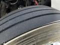 Close-up of a tire on a 2016 Freightliner M2 106 showing deep tread patterns and the brand logo on the sidewall