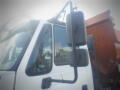 A 2016 International WorkStar 7500 truck with a prominent side mirror and a portion of the vehicle's front cab visible
