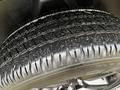 Close-up of a tire from a 2022 RAM 1500 Classic showing deep tread patterns and a clean surface with slight dirt