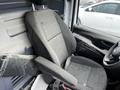 A clean gray driver's seat of a 2018 Mercedes-Benz Metris with an adjustable armrest and headrest