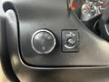 Close-up of the control panel in a 2017 Chevrolet Express featuring a dial for headlight settings and a switch for the dome light