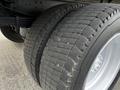 Close-up of the dual rear tires of a 2006 Hino 268 showing tread wear and pattern on a white wheel