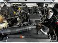Engine compartment of a 2010 Ford Ranger featuring the engine block air intake and various engine components with hoses and wires visible