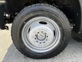 Close-up of a wheel from a 2016 Ford F-550 featuring a silver alloy rim and a black tire with visible tread details