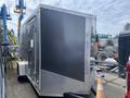 A 2020 Stealth Enterprises trailer with a sleek black exterior and diamond plate accents, featuring a side door and a sturdy frame