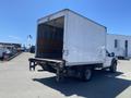 A 2015 Ford F-450 Super Duty truck with a white box trailer and an open rear cargo area