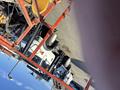 A 2010 SkyJack SJ aerial lift with a white and black color scheme featuring large wheels and a raised platform for reaching elevated work areas