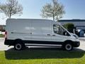 A white 2022 Ford Transit van is shown from the side with black accents on the lower body and wheels