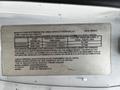 A 2019 Chevrolet Express van with specifications displayed on a label, including weight capacities and manufacturing details