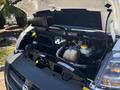 Engine compartment of a 2016 RAM Promaster with the hood open showcasing the engine components and fluid reservoirs