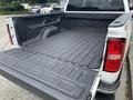 2016 GMC Sierra 1500 with an open truck bed featuring a textured liner and GMC logo embossed on the side