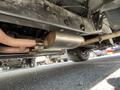 The underside of a 1962 Ford F-100 showing exhaust pipes and a muffler