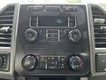 Dashboard of a 2017 Ford F-250 SD featuring a radio display with buttons for volume tuning and climate control settings