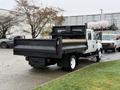 A 2012 International TerraStar truck with a flatbed and a black dump body parked on a lot