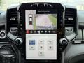 A close-up view of the infotainment display in a 2024 RAM 2500 showing a rearview camera feed and options for different camera views