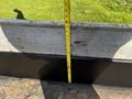 A 2021 Ford F-550 parked with a measuring tape extending from the edge of a surface, showing a gap measurement