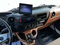 Interior of a 2021 Hino 338 truck featuring a dashboard with various controls a touchscreen display and a gear shift console