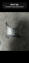 A shiny silver belt buckle featuring the word TAPOUT in bold letters with a stylized design