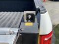 A close-up view of a 2016 Ford F-150 truck bed showing a metal component with a threaded fitting on the side of the bed near the tailgate