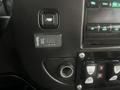 Close-up view of the dashboard controls of a 2017 Chevrolet Express featuring buttons and switches for various functions