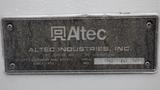 A metal nameplate displaying the Altec Industries logo along with information including utility equipment and body details and a serial number