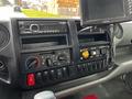 Dashboard of a 2018 Hino 195 featuring radio controls air conditioning knobs and various switches for vehicle functions