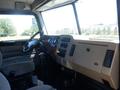 Interior view of a 2008 Peterbilt 335 featuring a driver's seat and dashboard with various gauges and controls