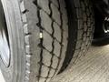 Close-up of a tire from a 2013 International 4200 showing distinct tread patterns and a small object lodged in the grooves